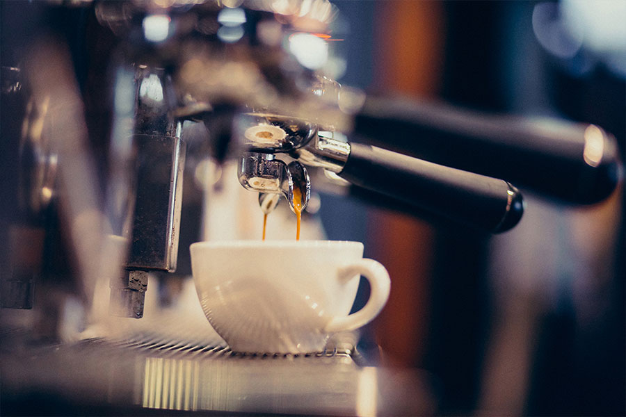 Coffee machine pulling an espresso shot.