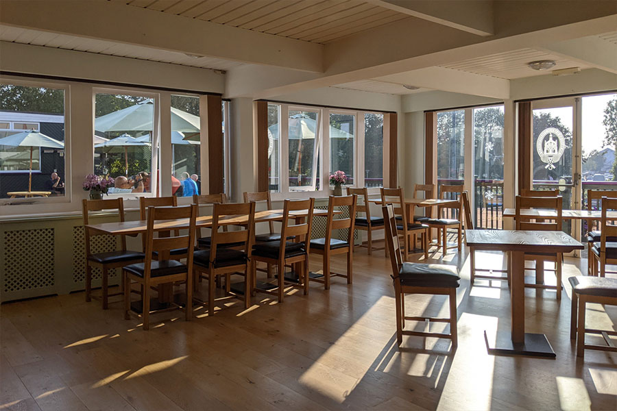The restaurant seating area with the summer sun shining through the windows.