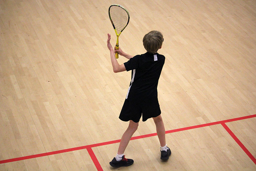 Junior squash player in a coaching session.