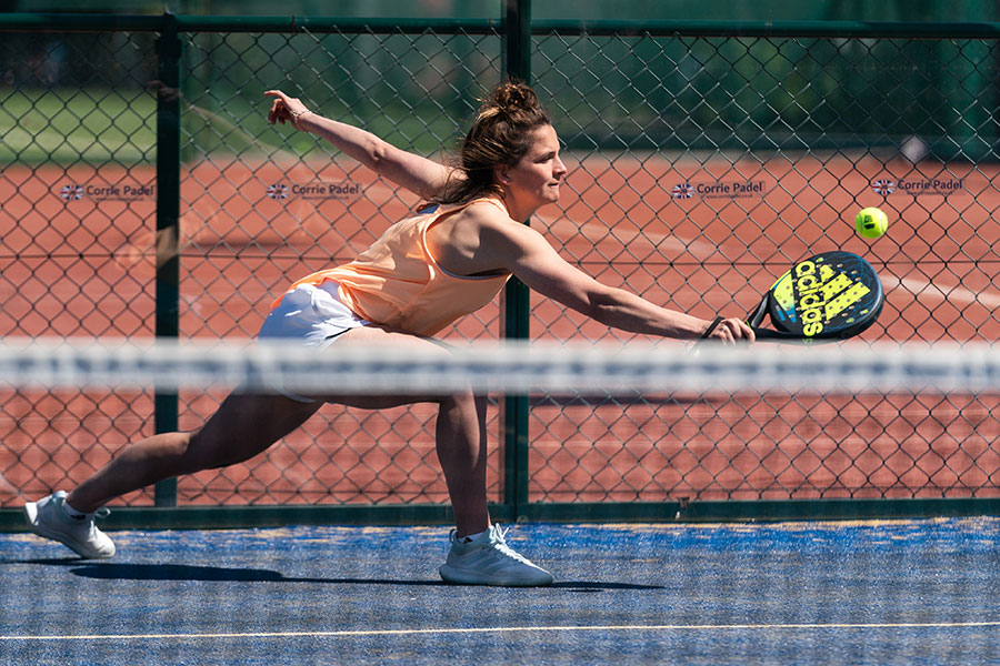 Woman taking part in a competitive padel match.