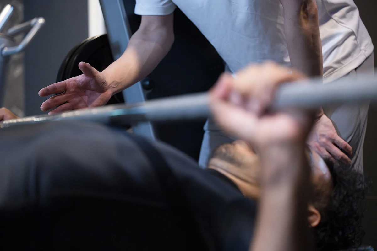 Closeuup of trainer teaching bench press.